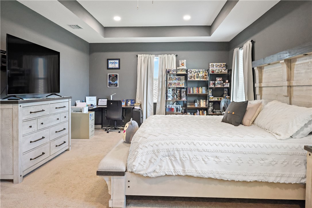 1782 Berkshire Circle Southwest Vero Beach, FL 32968 - Photo 17 of 35 a bedroom with a bed and a flat screen tv