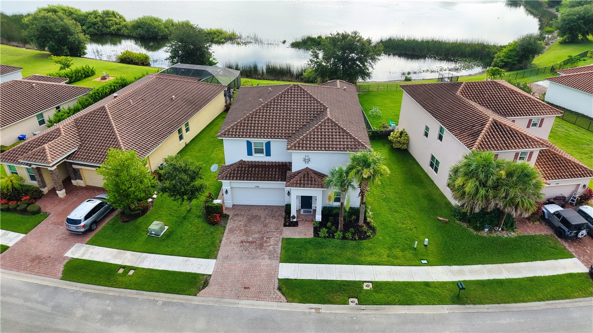 1782 Berkshire Circle Southwest Vero Beach, FL 32968 - Photo 2 of 35 an aerial view of multiple houses with yard