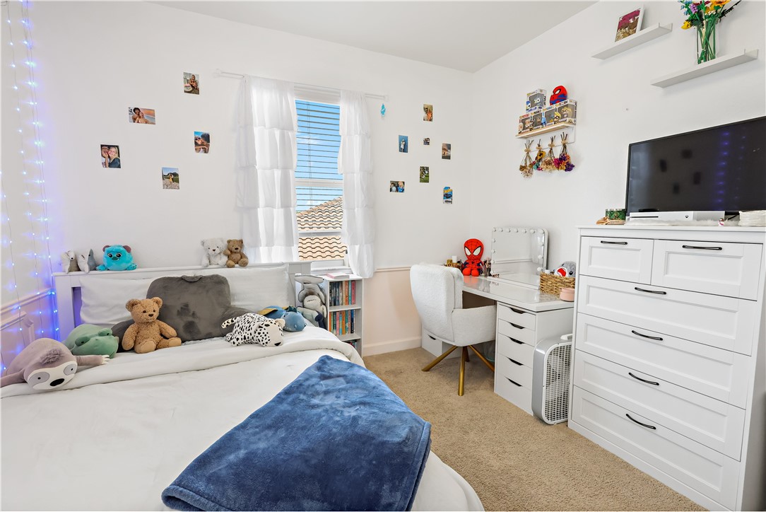 1782 Berkshire Circle Southwest Vero Beach, FL 32968 - Photo 21 of 35 a bedroom with a bed and a flat screen tv