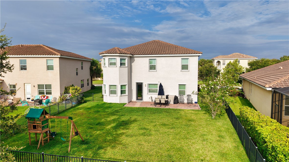 1782 Berkshire Circle Southwest Vero Beach, FL 32968 - Photo 3 of 35 a front view of a house with a yard