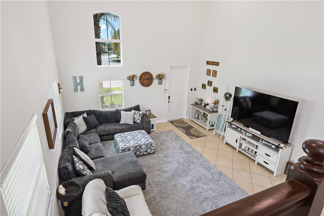 1782 Berkshire Circle Southwest Vero Beach, FL 32968 - Photo 7 of 35 a living room with furniture and a flat screen tv