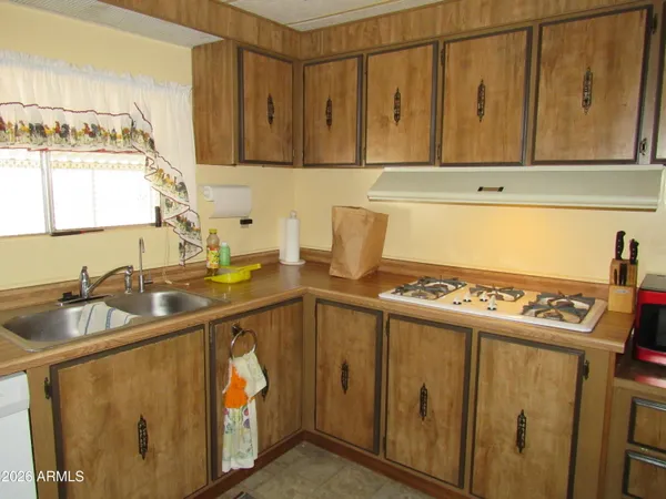 a kitchen with a sink stove and cabinets