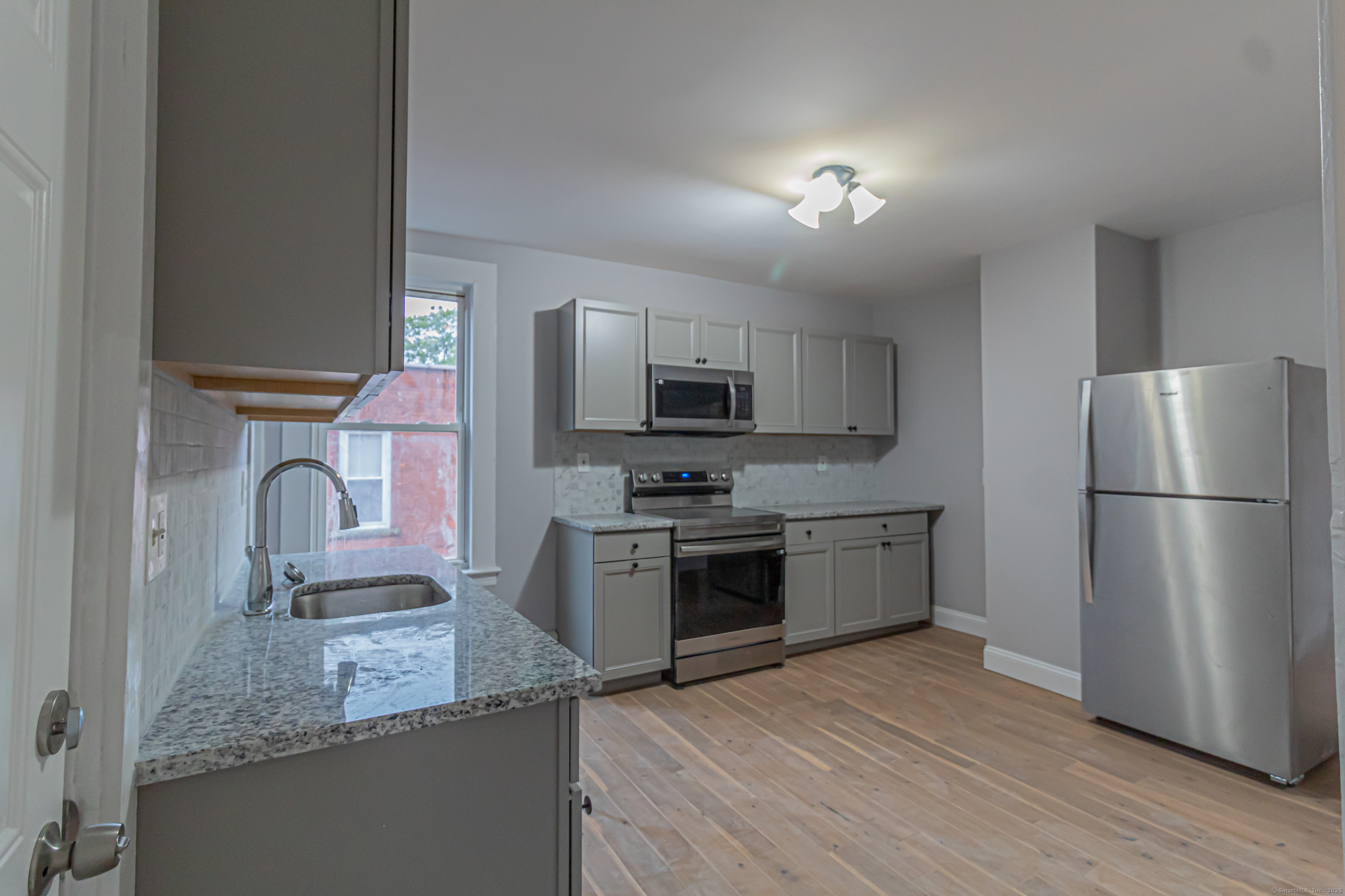 43-45 York Street, Unit 2 Hartford, CT 06106 - Photo 2 of 10 a kitchen with a sink stove and refrigerator