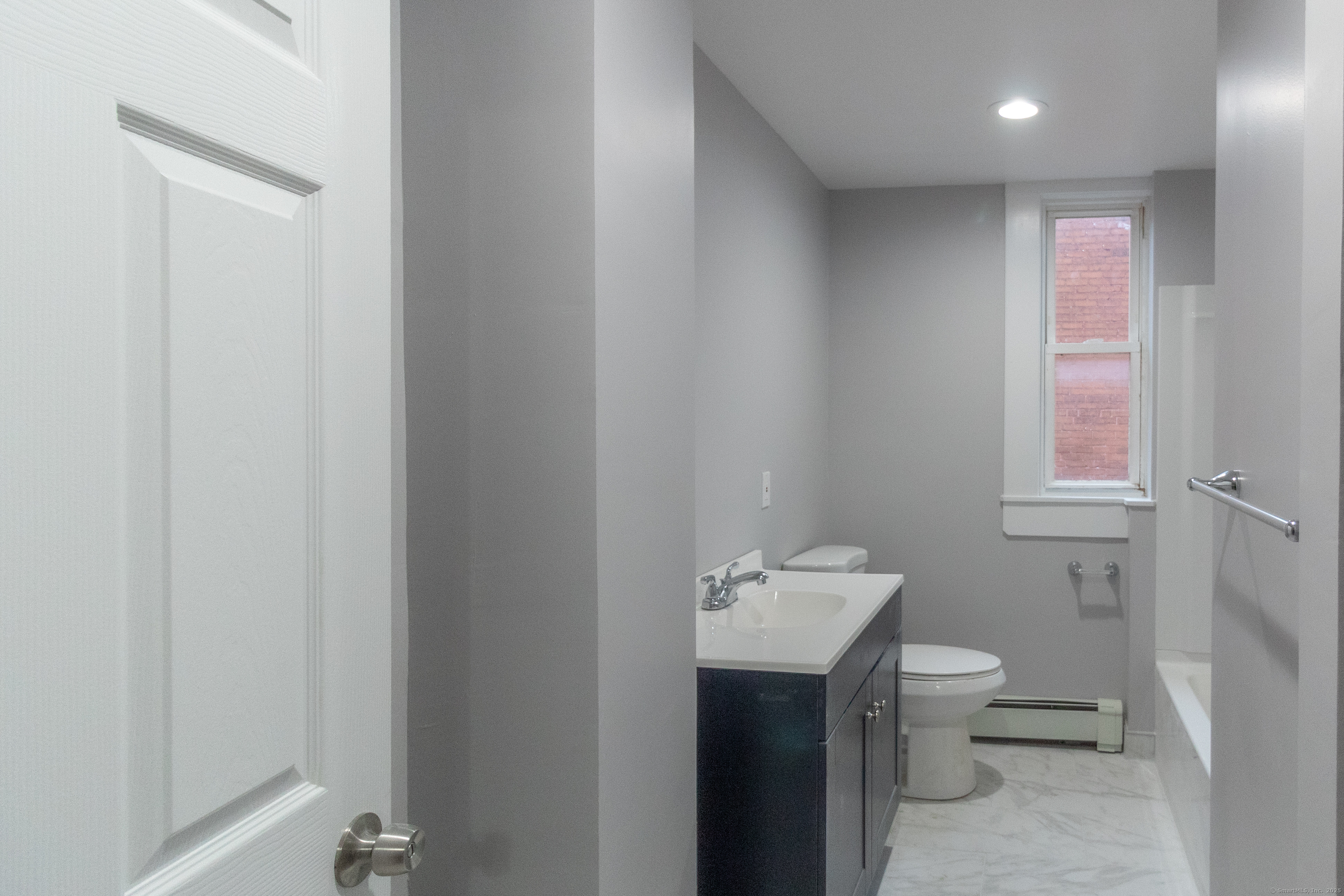 43-45 York Street, Unit 2 Hartford, CT 06106 - Photo 7 of 10 a bathroom with a toilet sink and mirror