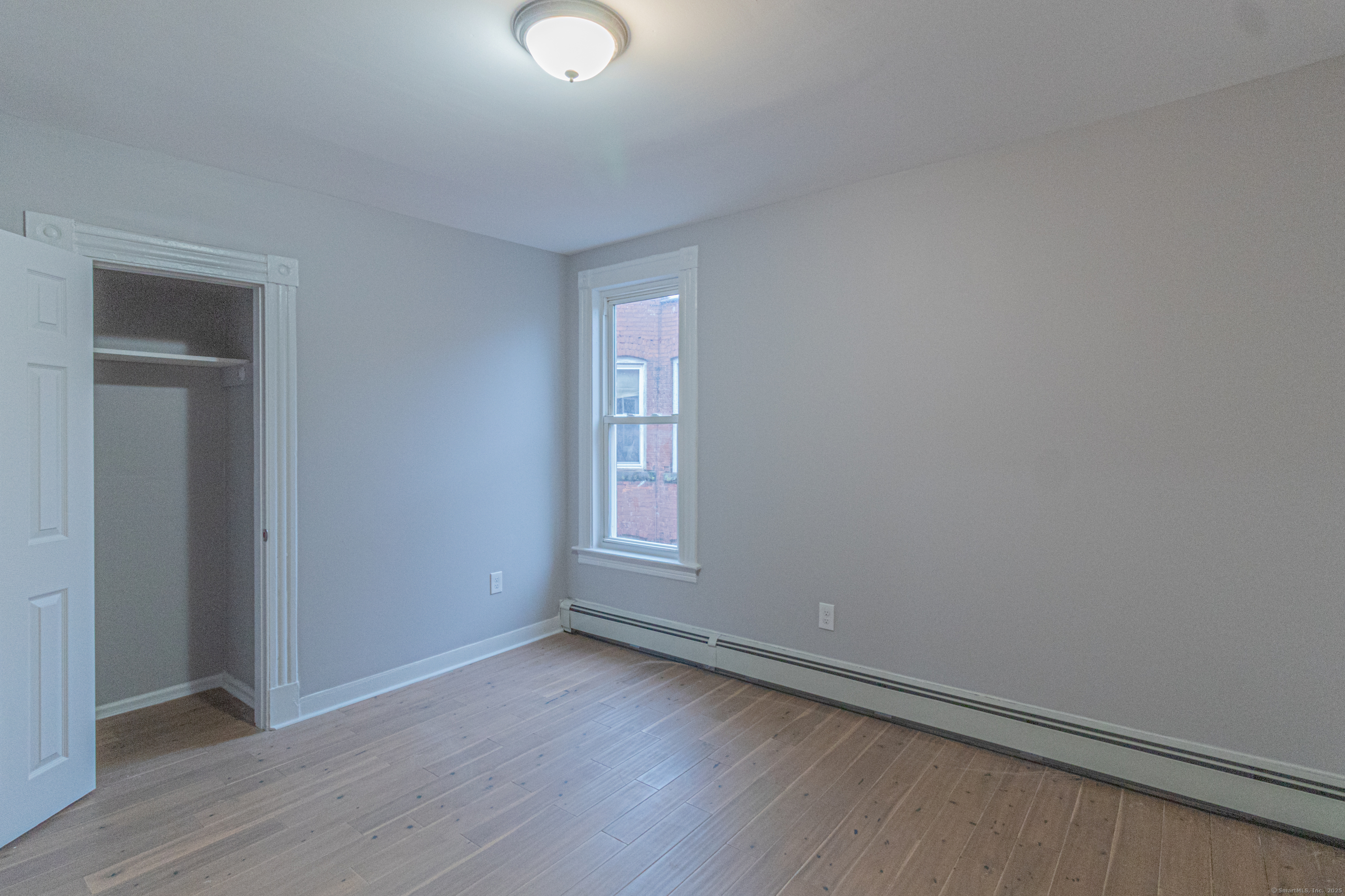 43-45 York Street, Unit 2 Hartford, CT 06106 - Photo 8 of 10 an empty room with wooden floor and windows