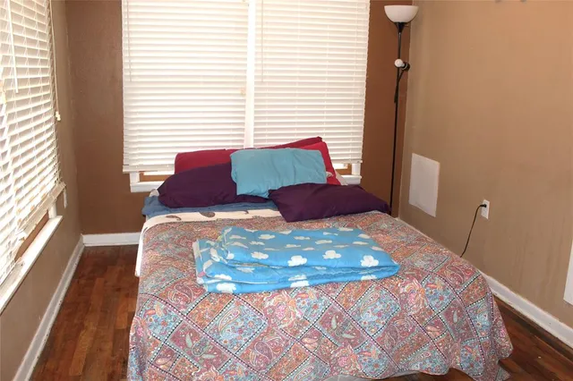 a bedroom with a large bed and a window