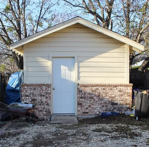 a small white house with a white roof and a yard