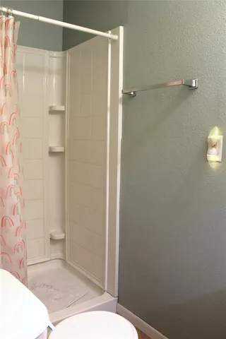 a bathroom with a shower and a toilet