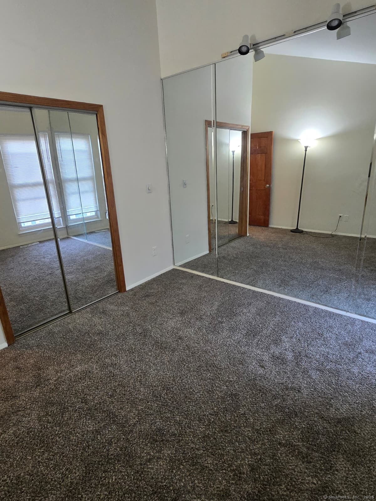 30 Glenview Drive, Unit 30 Cromwell, CT 06416 - Photo 16 of 22 a view of an empty room with wooden floor and a mirror