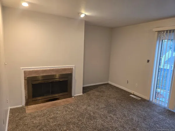 an empty room with a fireplace
