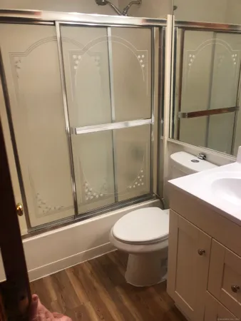 a bathroom with a sink toilet and shower
