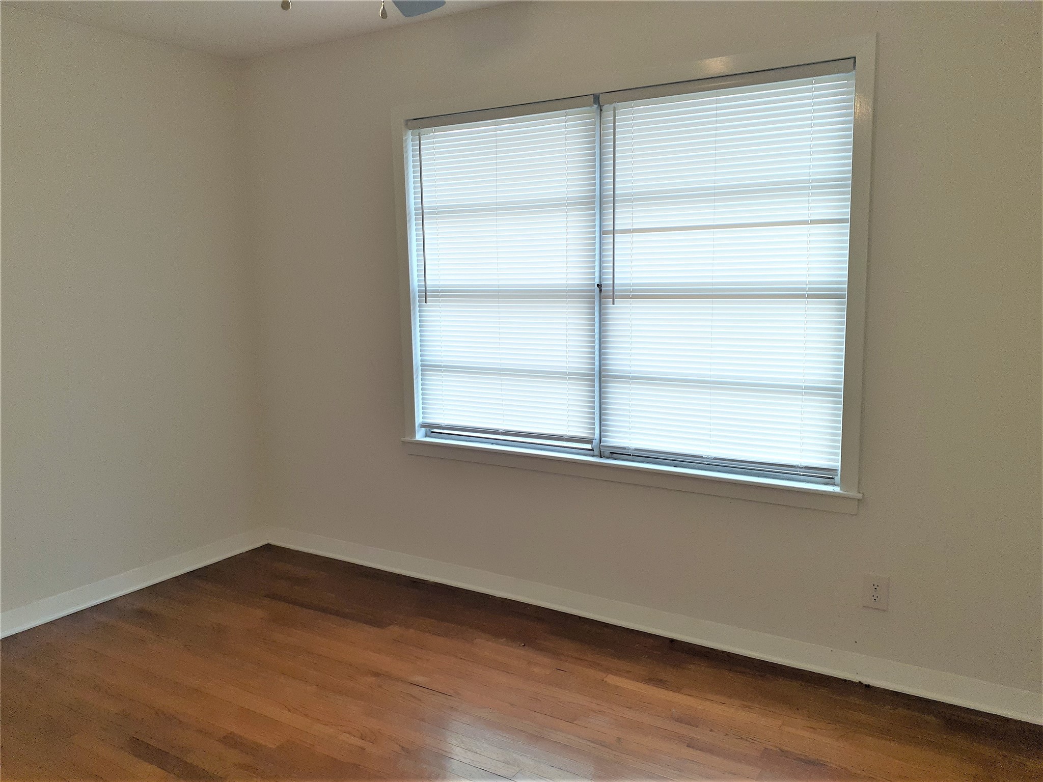1213 Tobola Street Rosenberg, TX 77471 - Photo 8 of 8 a view of a small space with wooden floor and a window