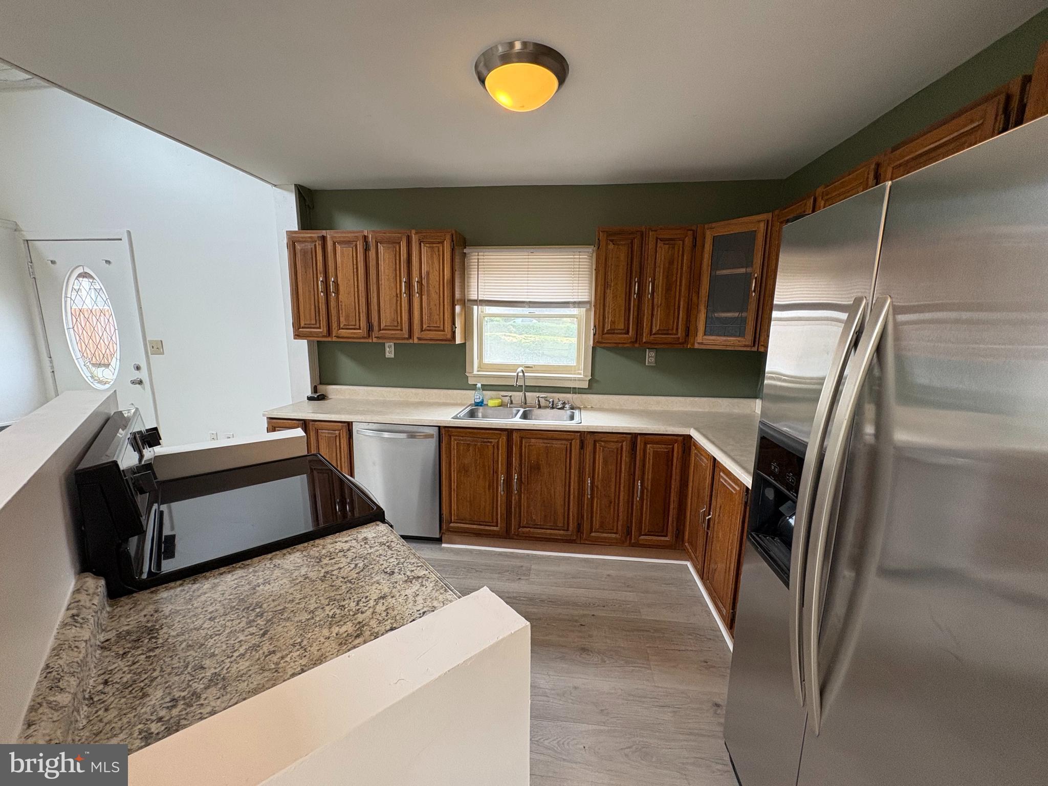 5001 Carroll Manor Road Baldwin, MD 21013 - Photo 6 of 18 a kitchen with stainless steel appliances granite countertop a sink stove and refrigerator