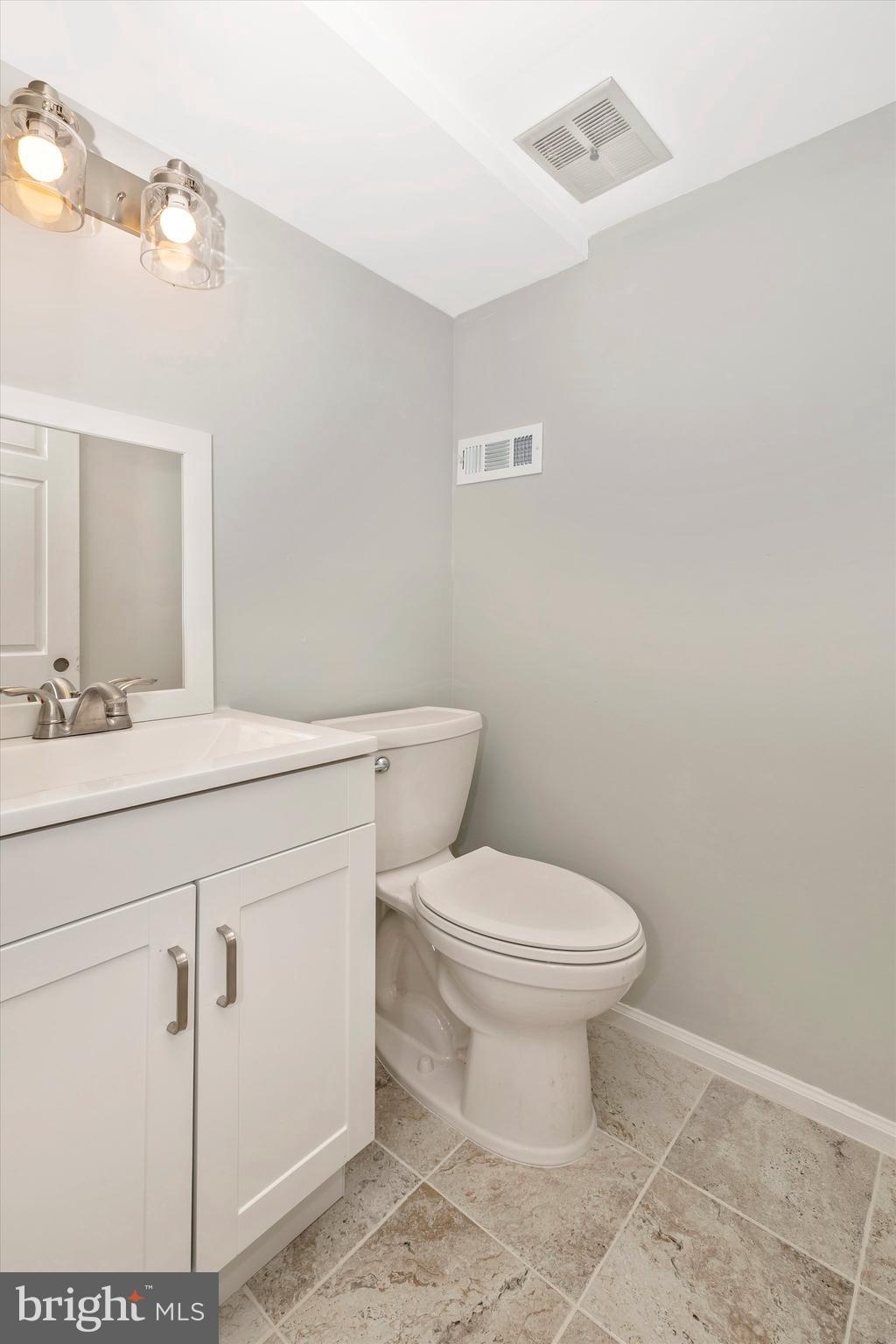8001 Hollow Reed Court Frederick, MD 21701 - Photo 17 of 33 a bathroom with a sink toilet and vanity