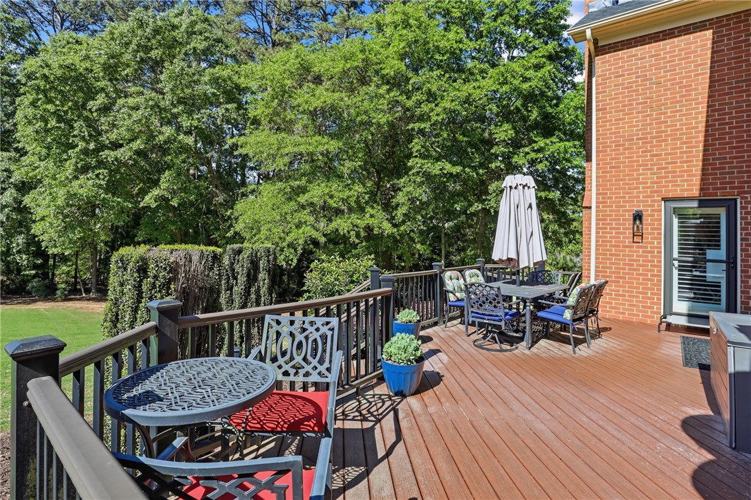 103 5 Knoll Court Anderson, SC 29621 - Photo 26 of 33 An inviting outdoor deck provides ample space for relaxation and al fresco dining, surrounded by lush green foliage.