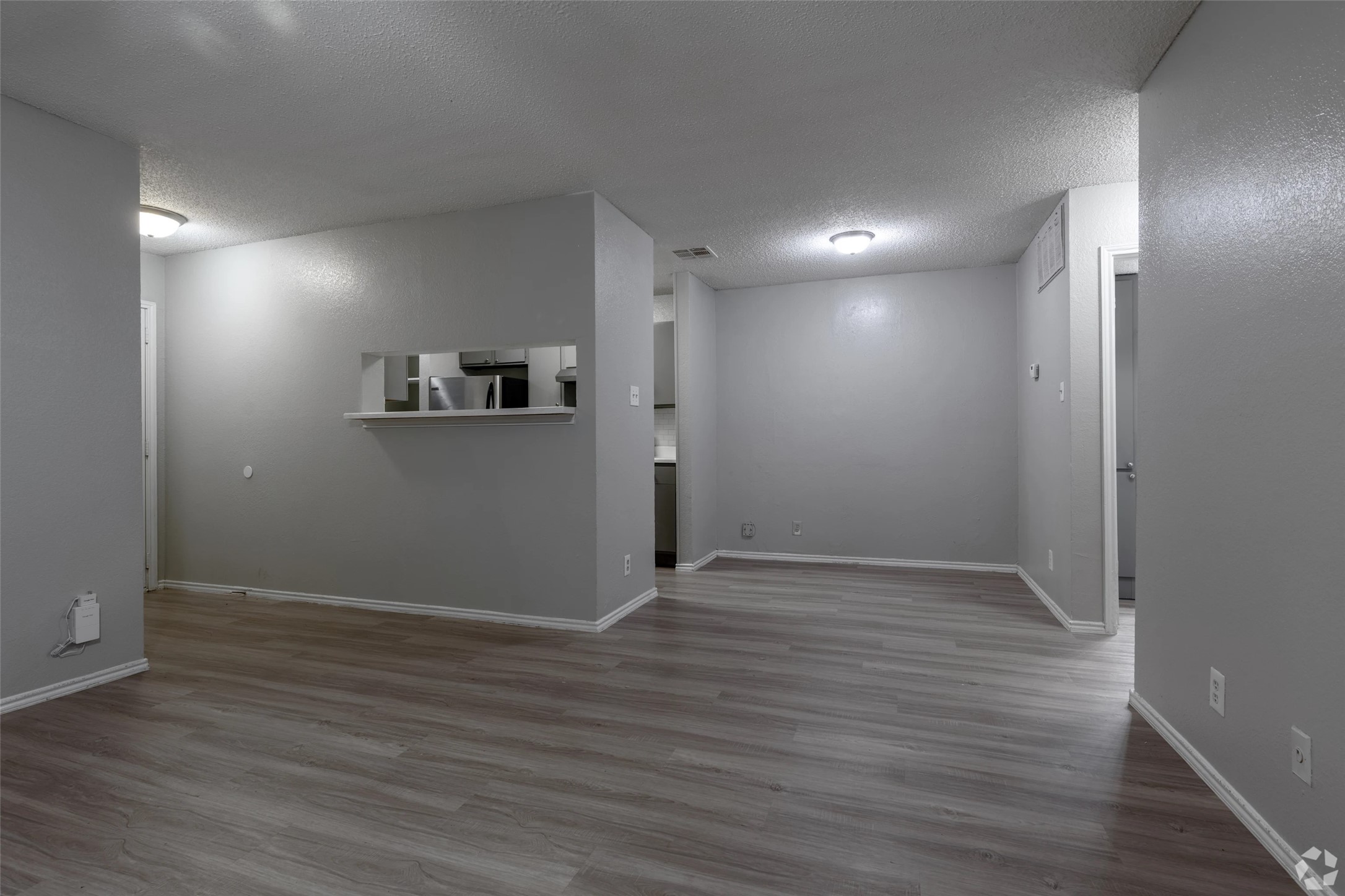 7610 Cameron Road, Unit 1013 Austin, TX 78752 - Photo 3 of 42 a view of an empty room with wooden floor and a window