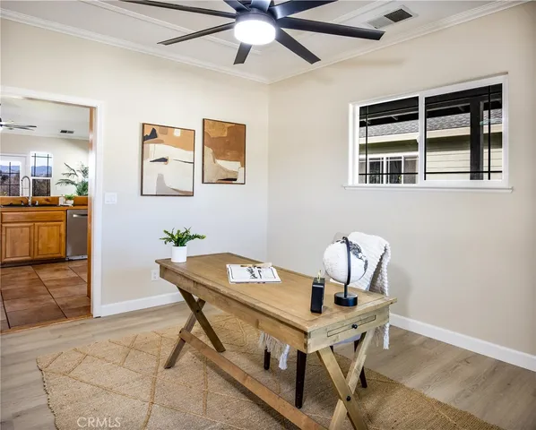 a room with table chairs and ceiling fan