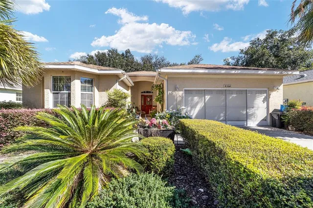 a view of a house with a small yard and plants
