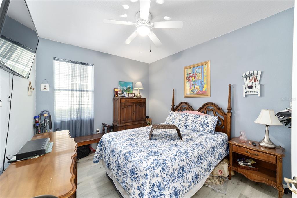 8364 Southwest 79th Circle Ocala, FL 34476 - Photo 17 of 40 a bedroom with a bed and wooden floor