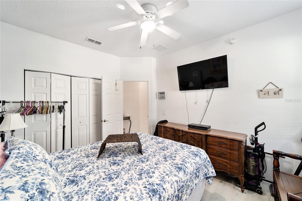 8364 Southwest 79th Circle Ocala, FL 34476 - Photo 18 of 40 a bedroom with a bed and a flat screen tv