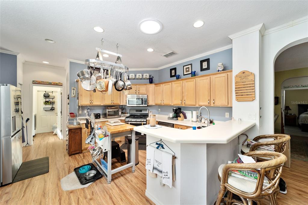 8364 Southwest 79th Circle Ocala, FL 34476 - Photo 22 of 40 a kitchen that has a lot of cabinets a sink and appliances in it