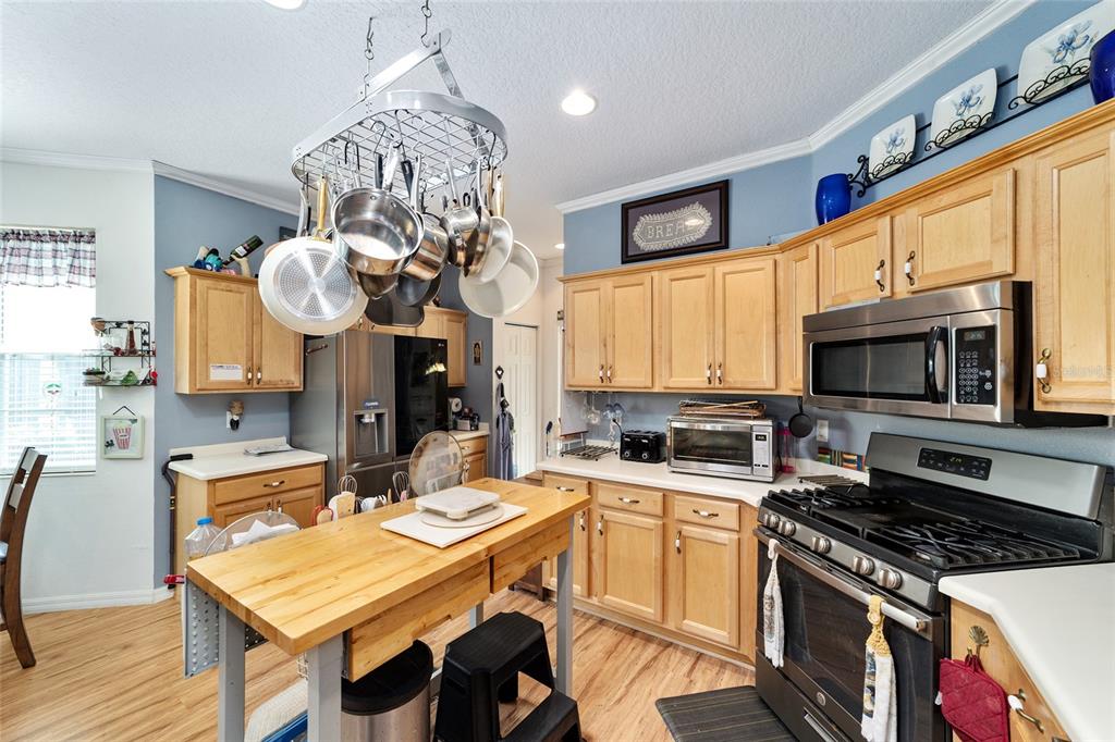 8364 Southwest 79th Circle Ocala, FL 34476 - Photo 24 of 40 a kitchen with stainless steel appliances granite countertop a sink a stove oven a counter space and cabinets