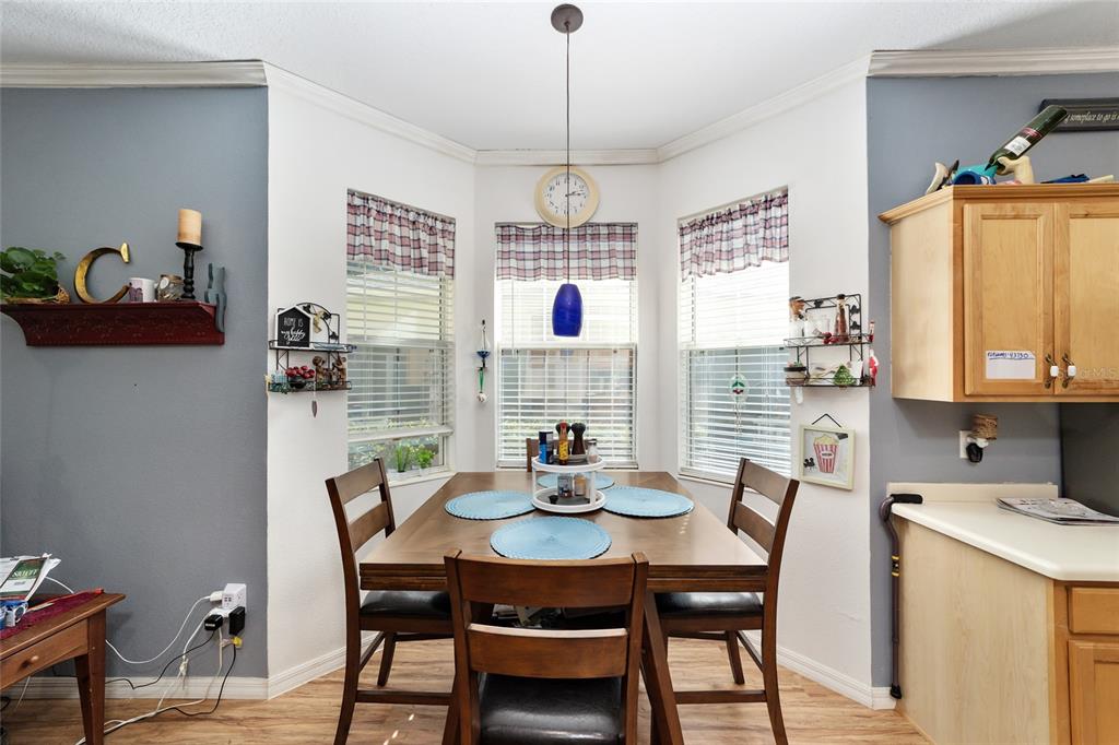 8364 Southwest 79th Circle Ocala, FL 34476 - Photo 27 of 40 a dining room with furniture window and wooden floor