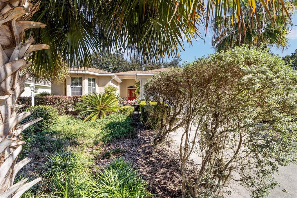 8364 Southwest 79th Circle Ocala, FL 34476 - Photo 5 of 40 a front view of a house with a garden