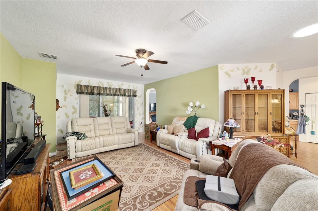 8364 Southwest 79th Circle Ocala, FL 34476 - Photo 10 of 40 a living room with furniture ceiling fan and a rug