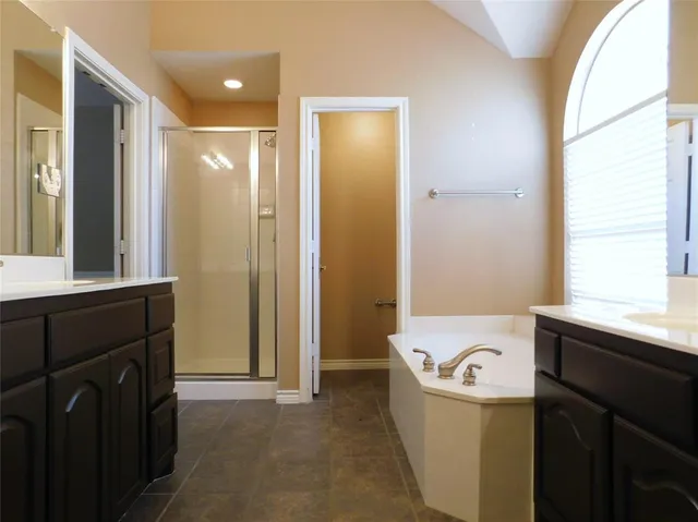 a bathroom with a bathtub sink and mirror