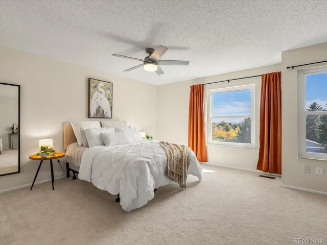 a bedroom with a bed and a couch