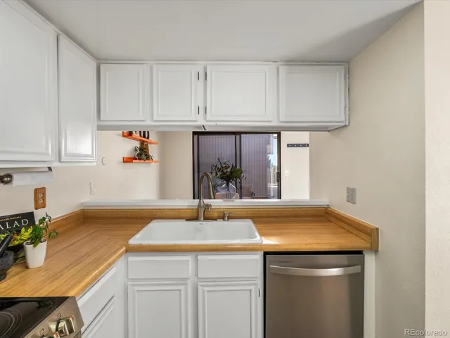 a kitchen with stainless steel appliances a refrigerator sink and cabinets