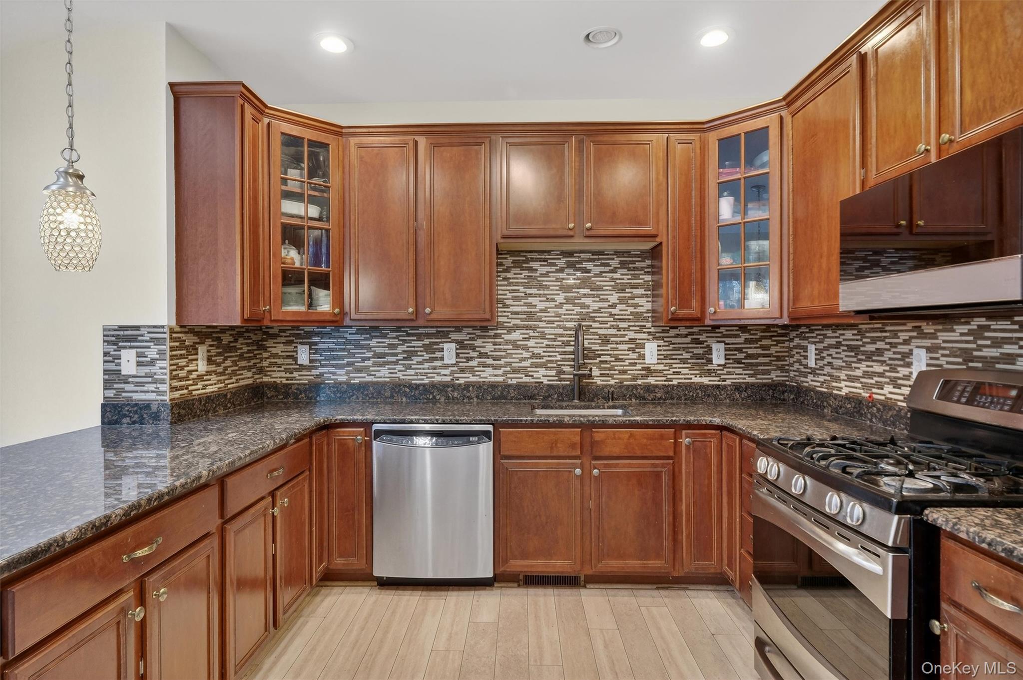 1123 Cold Spring Road Fishkill, NY 12524 - Photo 13 of 44 a kitchen with stainless steel appliances wooden cabinets and a stove top oven