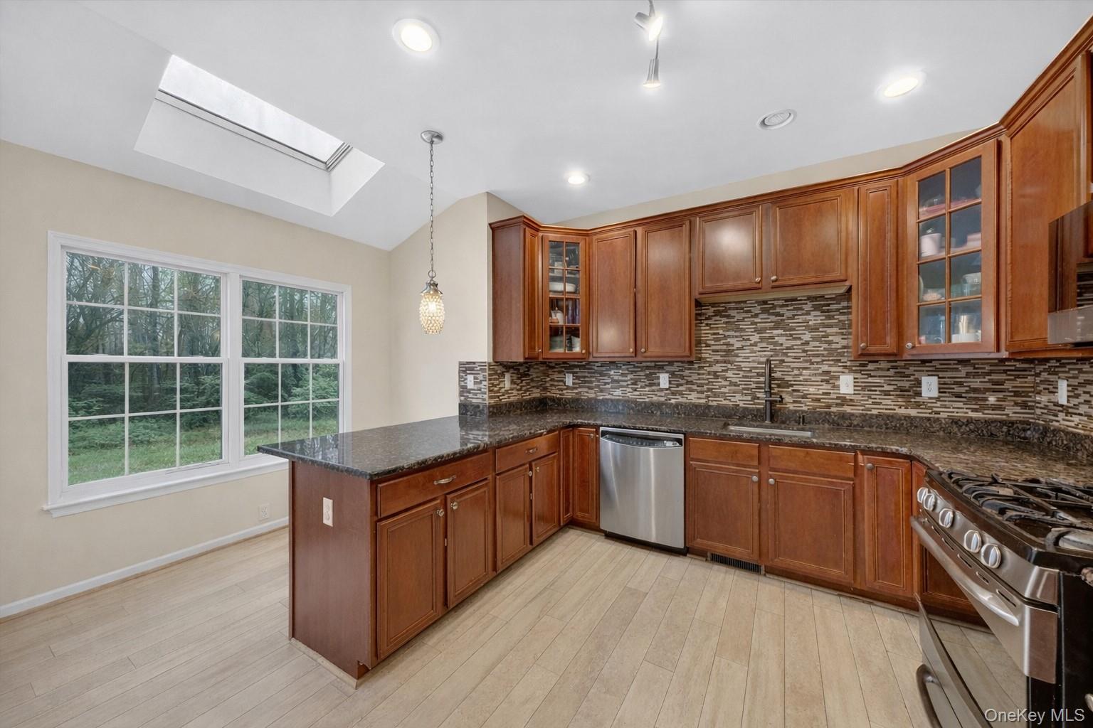 1123 Cold Spring Road Fishkill, NY 12524 - Photo 14 of 44 a kitchen with stainless steel appliances granite countertop wooden cabinets a sink dishwasher a stove and a refrigerator