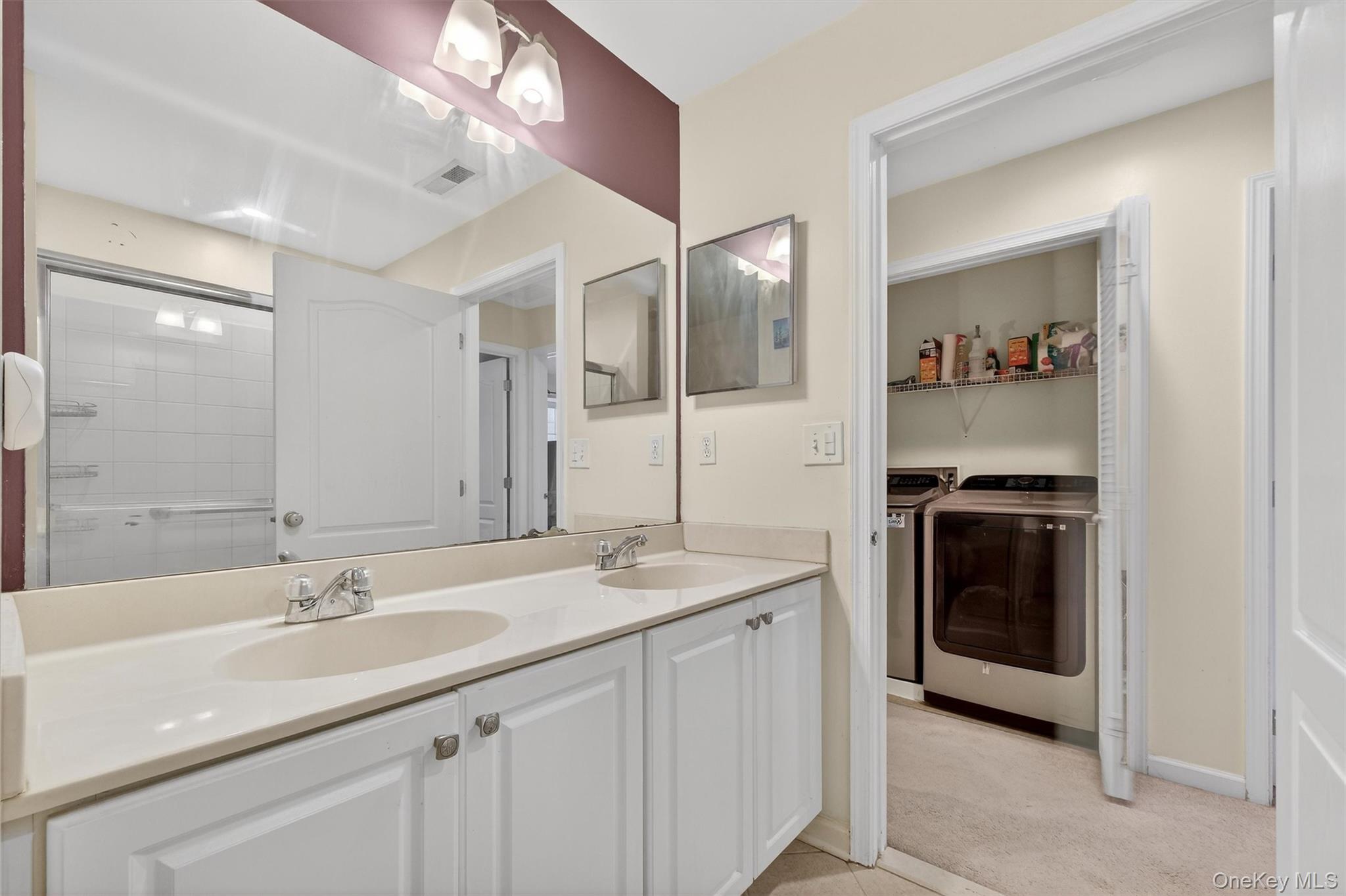 1123 Cold Spring Road Fishkill, NY 12524 - Photo 35 of 44 a en suite bathroom with a sink double vanity and a mirror