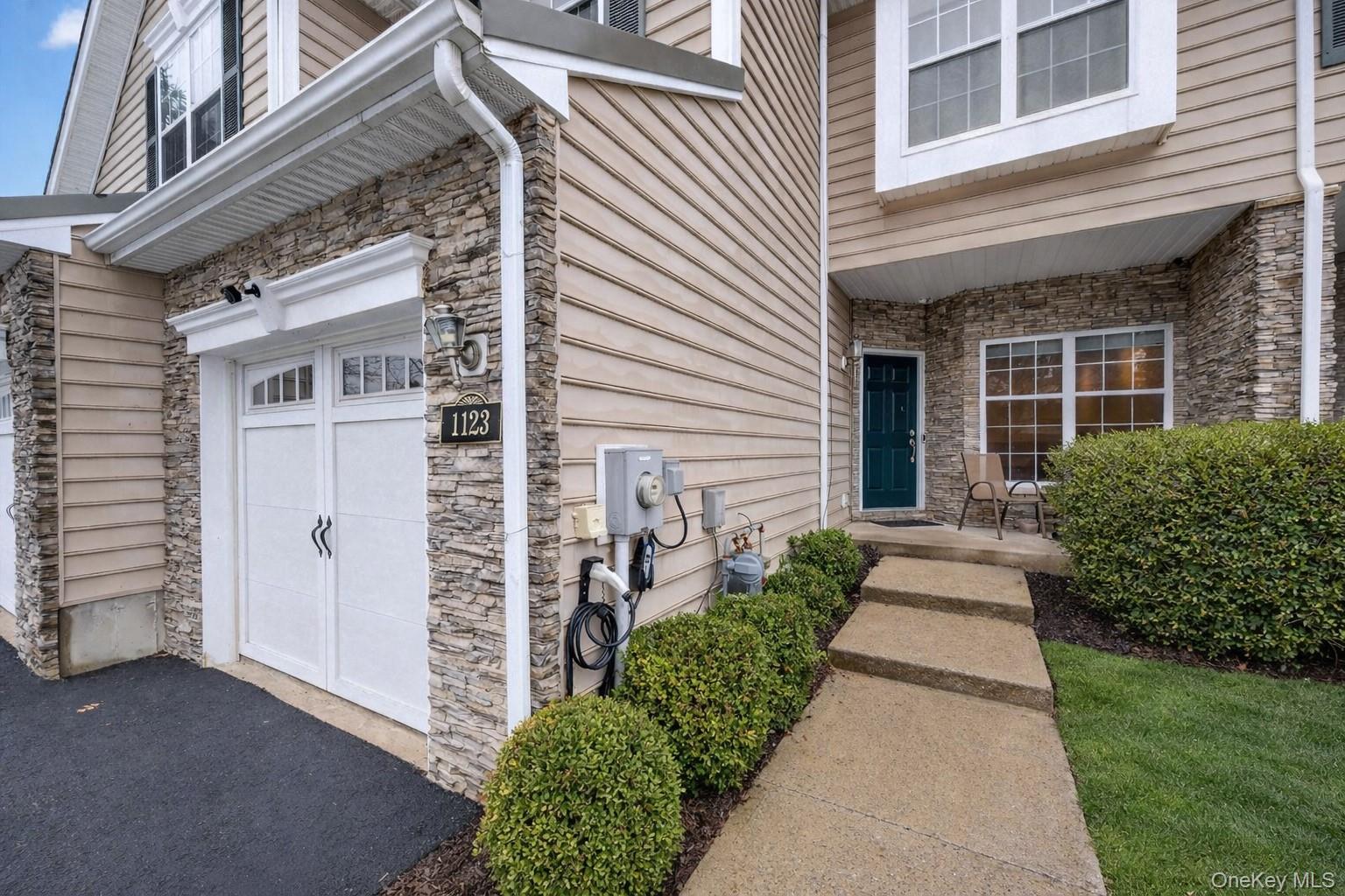1123 Cold Spring Road Fishkill, NY 12524 - Photo 40 of 44 a view of a house with brick walls plants and large tree