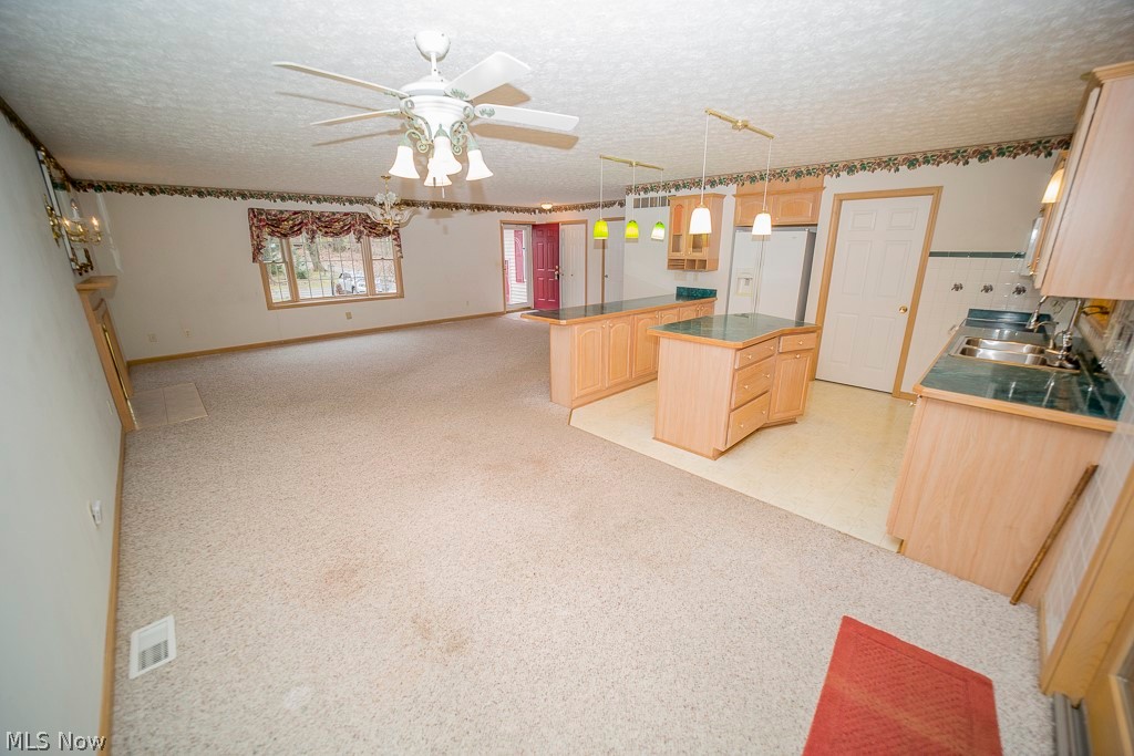 48120 Cooper Foster Park Road Amherst, OH 44001 - Photo 3 of 29 Opposite view from 4 season room. Laundry room is the closed door in the kitchen wall by the island.