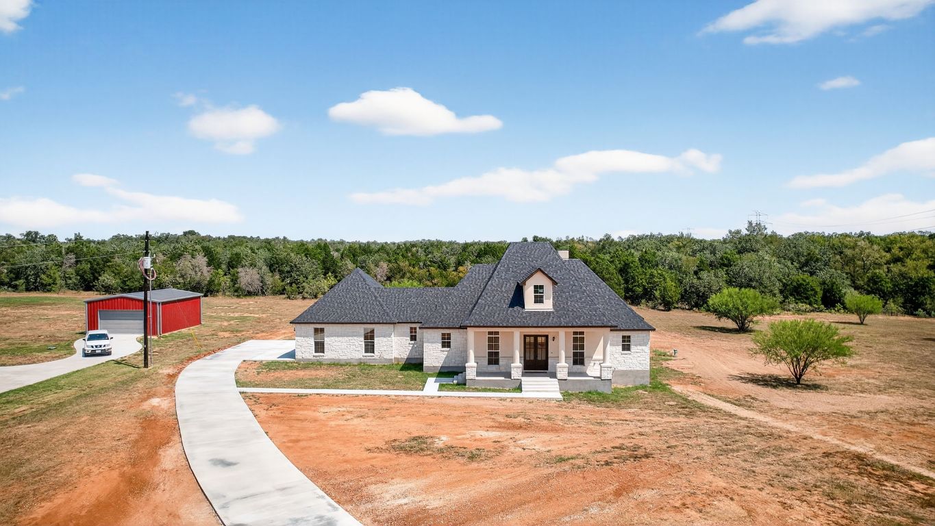 1035 Brandywine Court Elgin, TX 78621 - Photo 1 of 26 a front view of a house with a garden