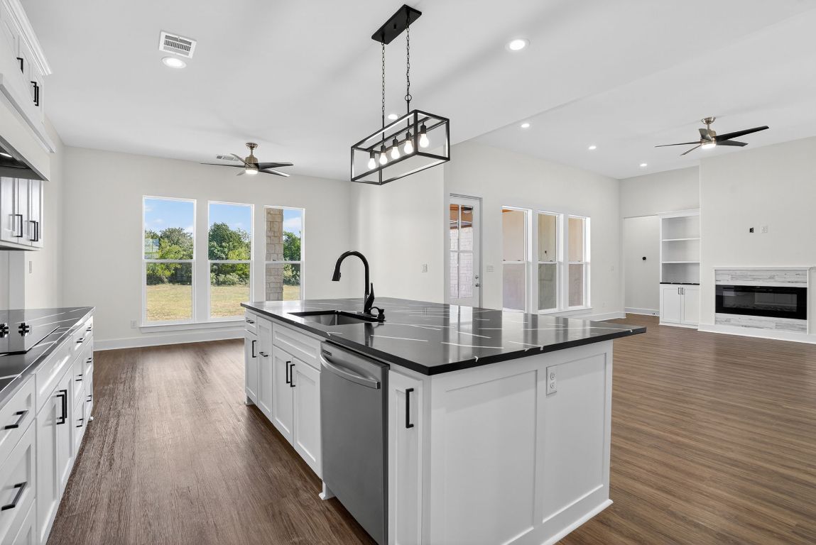 1035 Brandywine Court Elgin, TX 78621 - Photo 26 of 26 a kitchen with stainless steel appliances granite countertop a sink stove and wooden floor