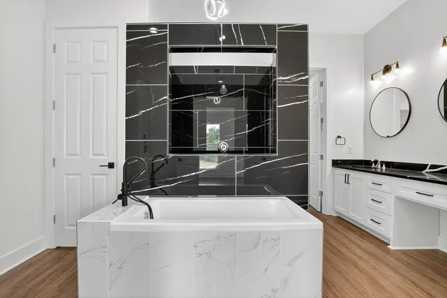 a kitchen with stainless steel appliances granite countertop a sink stove and wooden floor