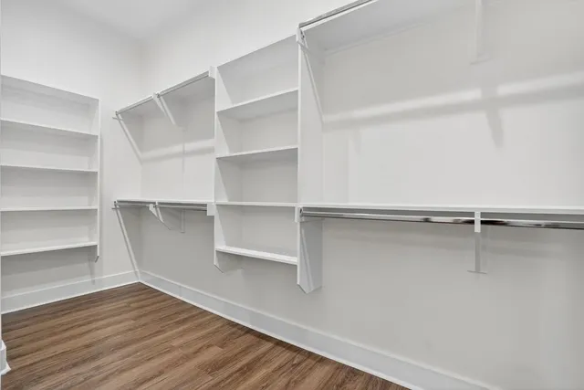 a view of walk in closet with empty racks