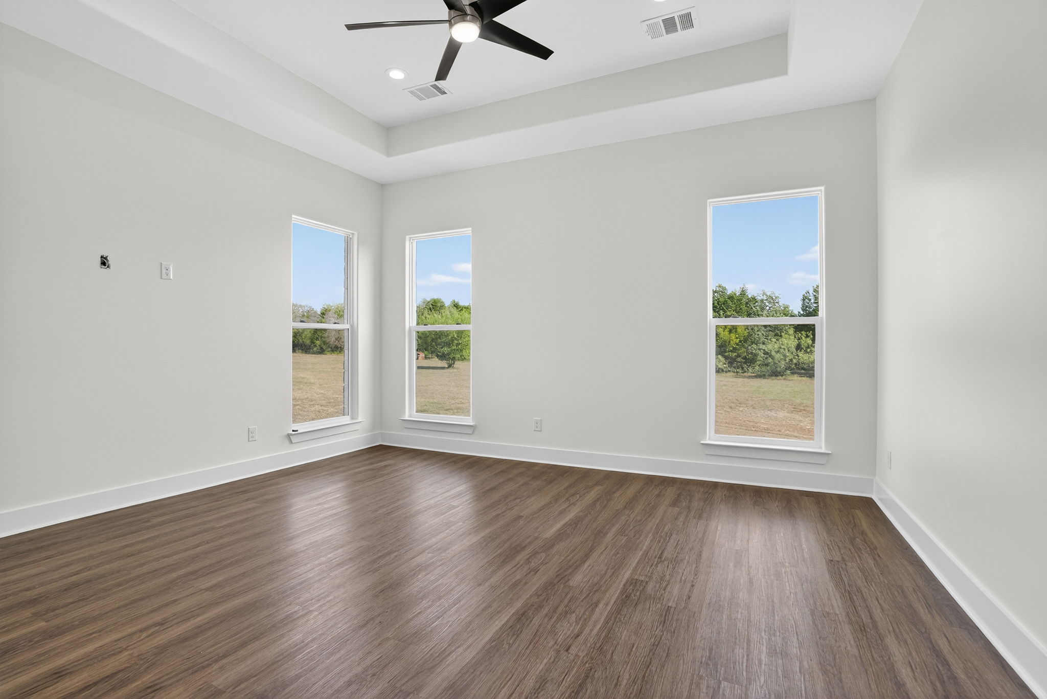 1035 Brandywine Court Elgin, TX 78621 - Photo 17 of 26 a view of an empty room with wooden floor and a window