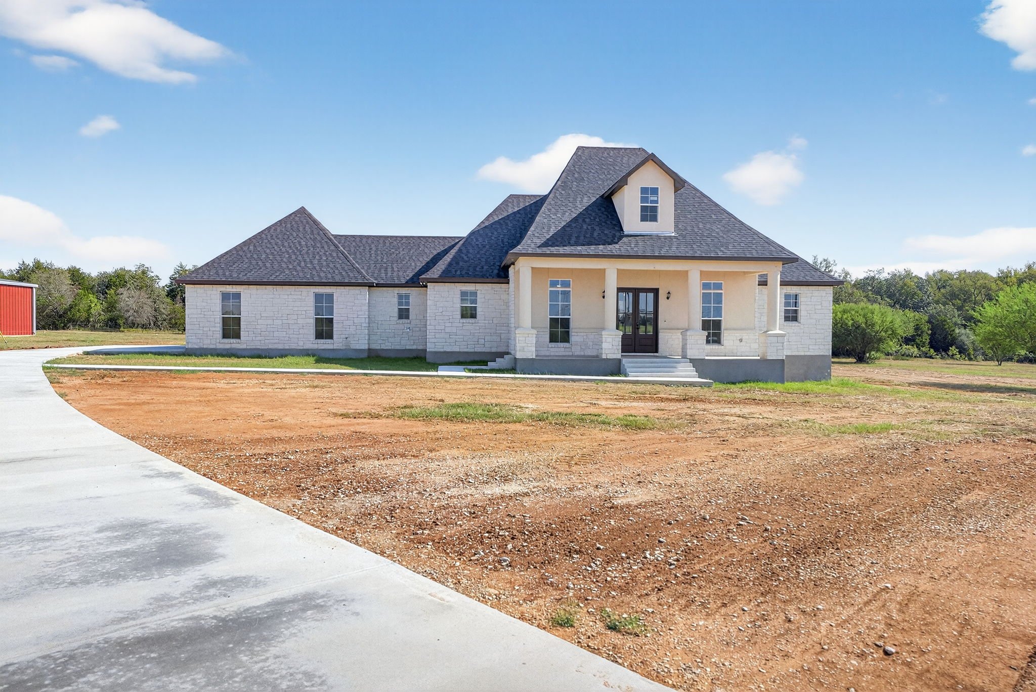 1035 Brandywine Court Elgin, TX 78621 - Photo 2 of 26 a view of a big house with a big yard and large trees