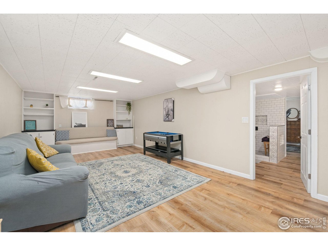 2114 18th Street Road Greeley, CO 80631 - Photo 28 of 35 Basement rec room with new LVP flooring