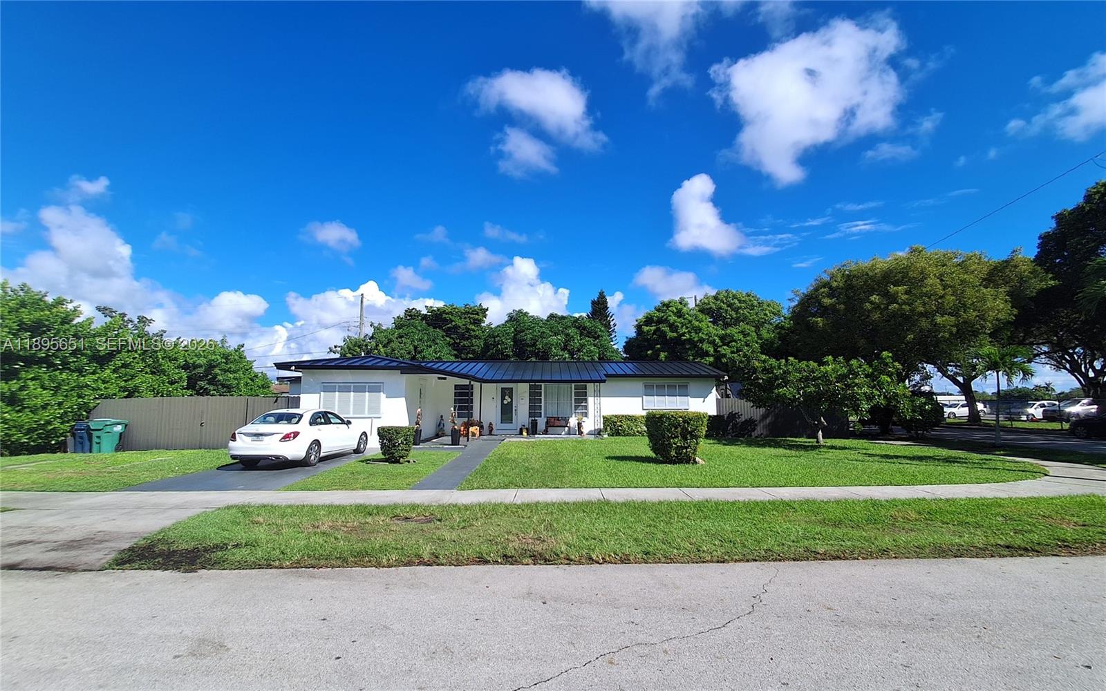 a front view of a house with a yard and green space