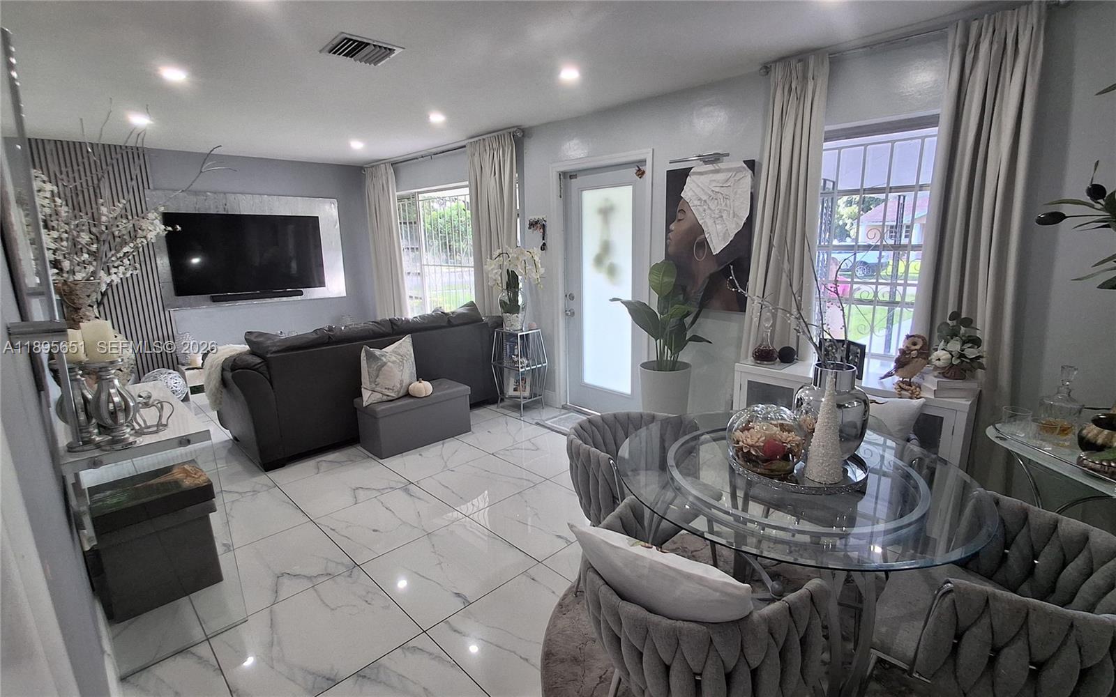 10305 Southwest 149th Terrace Miami, FL 33176 - Photo 13 of 58 a living room with furniture and a flat screen tv