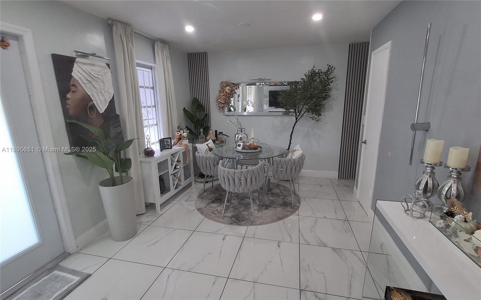 10305 Southwest 149th Terrace Miami, FL 33176 - Photo 14 of 39 a dining room with furniture and a flat screen tv