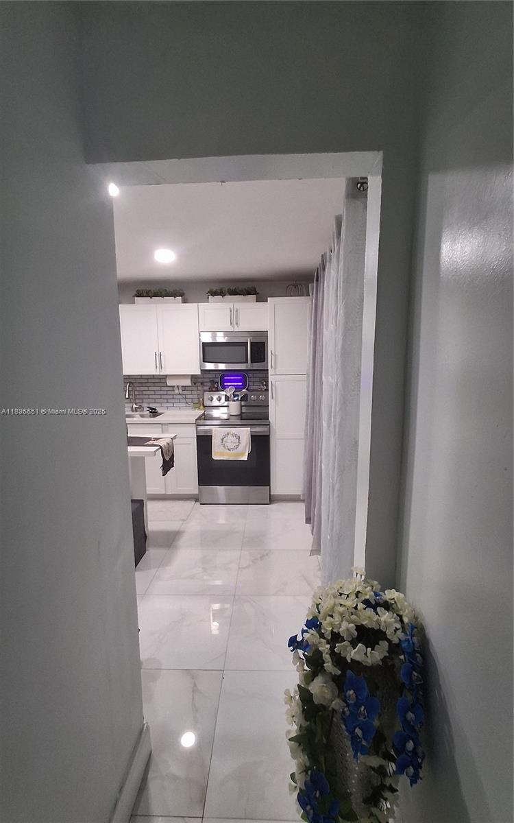 10305 Southwest 149th Terrace Miami, FL 33176 - Photo 17 of 39 a kitchen with stainless steel appliances a refrigerator and stove