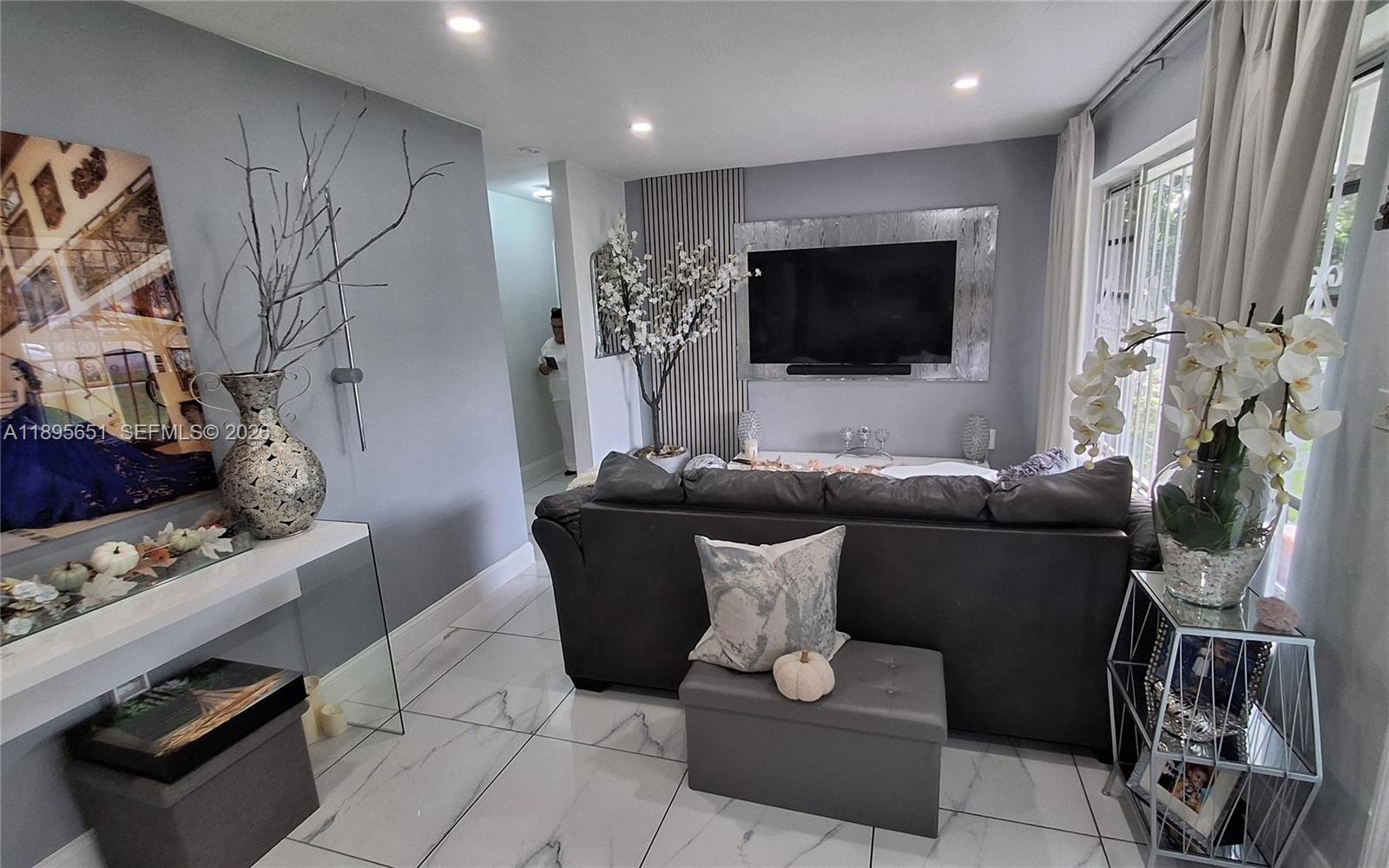 10305 Southwest 149th Terrace Miami, FL 33176 - Photo 17 of 58 a living room with furniture and a flat screen tv