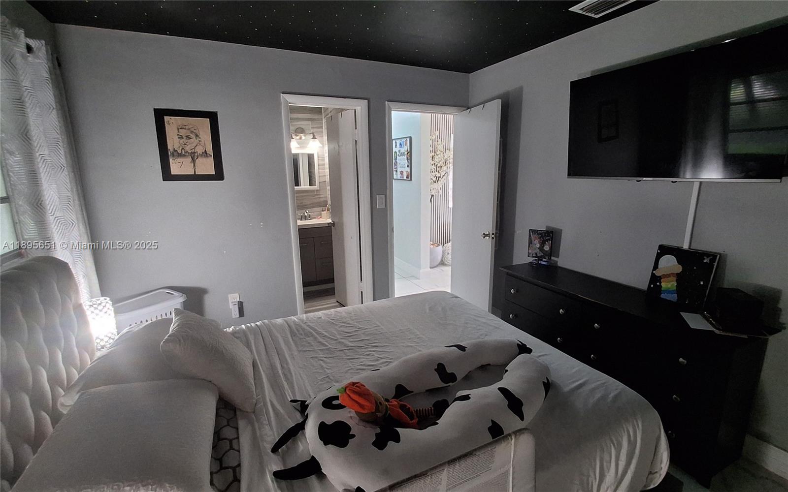 10305 Southwest 149th Terrace Miami, FL 33176 - Photo 2 of 39 a bedroom with a bed and wooden floor